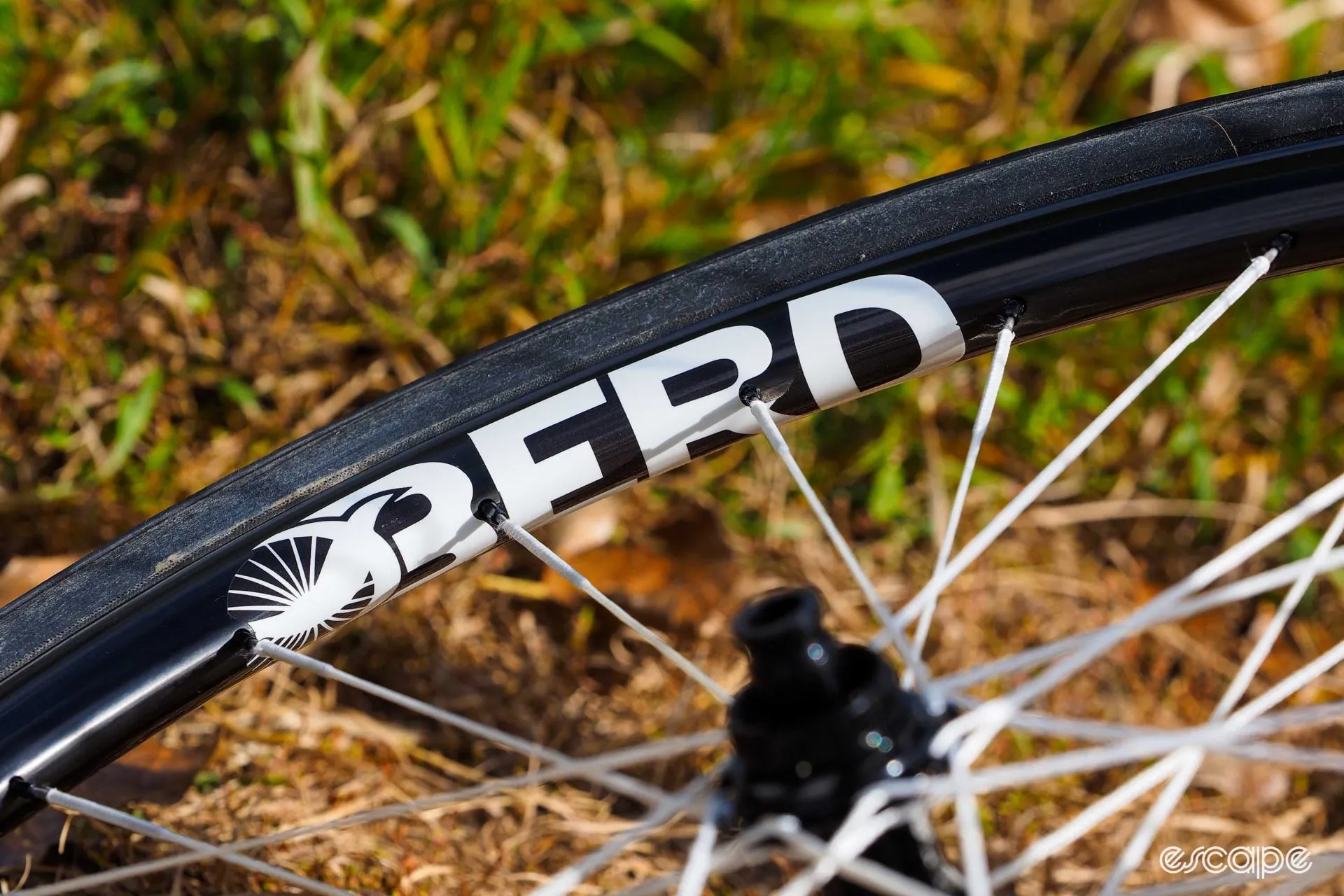 A close view of a BERD wheel rim and its white polymer spokes